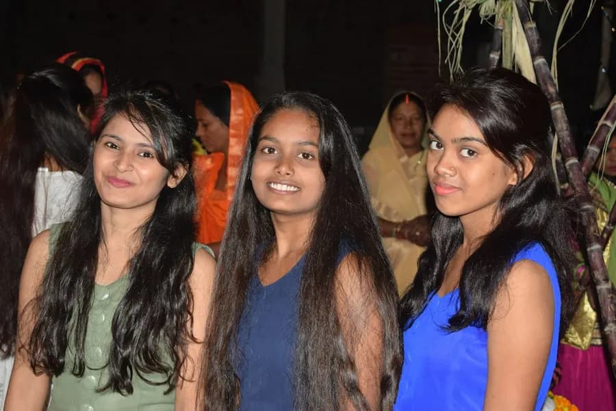 Three young women smiling together
